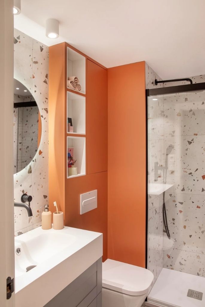 Vibrant Bathroom with Orange Accent Wall