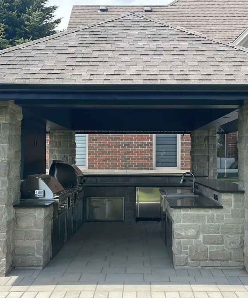 Outdoor Kitchen with Dual Grills and Stone Structure