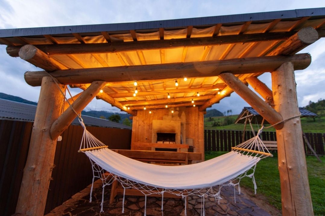 Cozy Outdoor Pergola with Hammock and String Lights